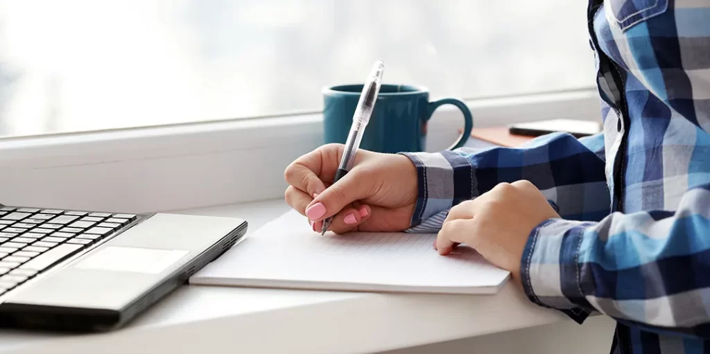 women writes notebook image