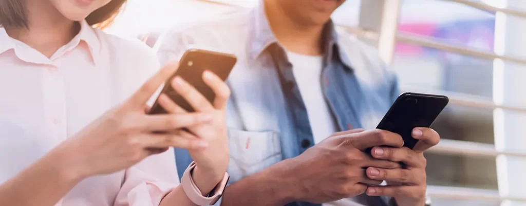 young people are using smartphone smiling image